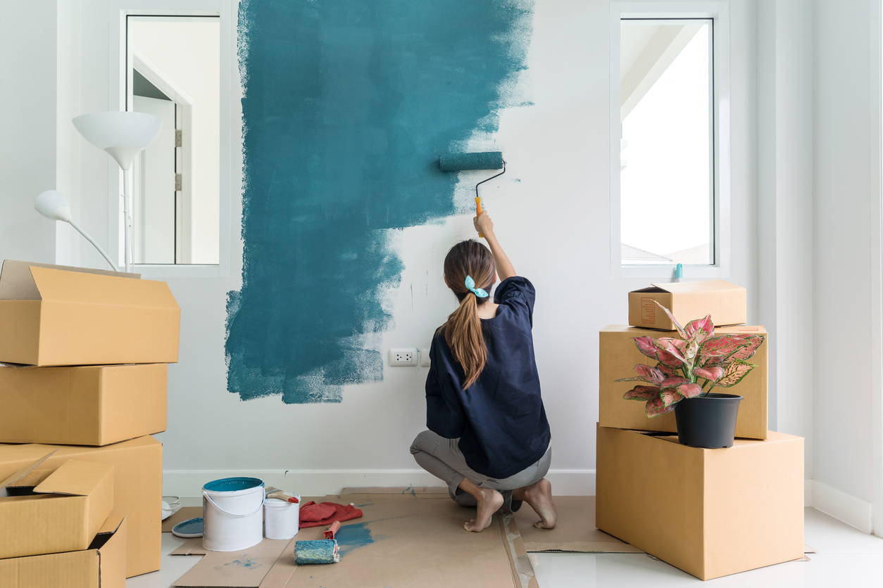 woman painting interior wall