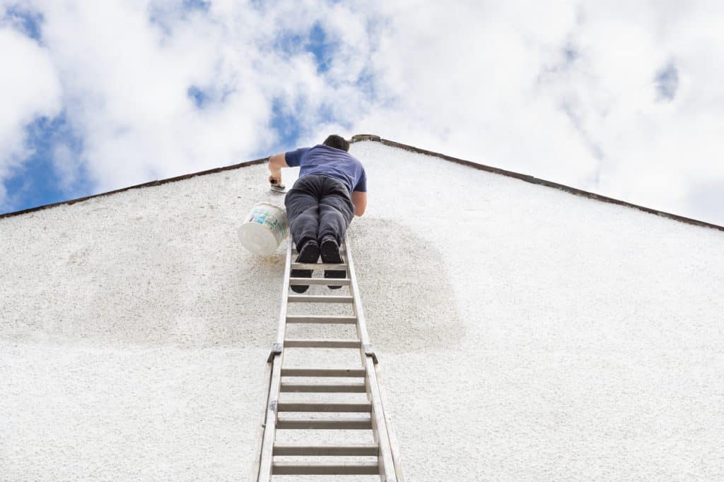 Man painting house